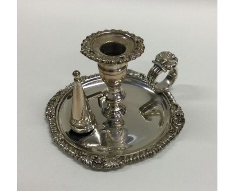 A miniature Georgian silver taper stick together with matching snuffer and gadroon rim. London 1820. By JC&amp;WR. Approx. 12