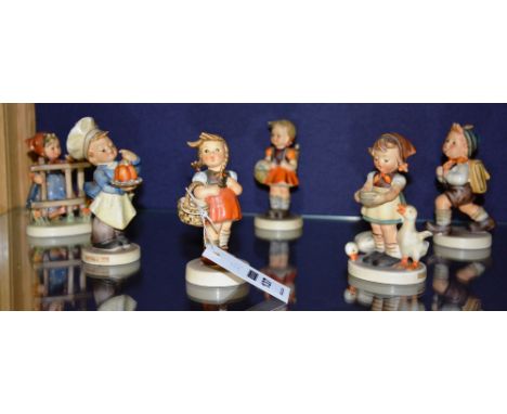 Six Hummel figures by Goebel, comprising of 'Signs of Spring', 'School Boy', 'School Girl', 'Little Shopper', 'Baker' and 'Be