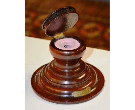 A wooden inkwell, made from timber taken from HMS Britannia, with ceramic insert, plaque to front, 11cm high