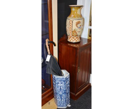 A Chinese style blue and white pottery stick stand, of hexagonal form, with white foliate decoration on blue ground, 46cm hig