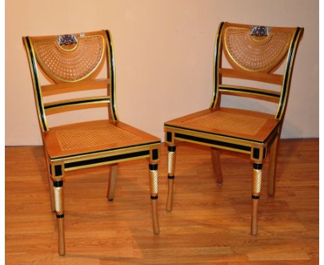 A set of four light oak bergere dining chairs by Clive Christian, in the Regency style, the top rail painted with coat of arm
