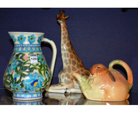 A 20th century Indian pottery jug, decorated with blue and green foliate panels on white ground, 21cm high, together with a R
