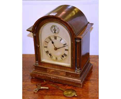 An Edwardian mahogany cased domed bracket clock, the silvered dial with subsidiary dial, 30cm high