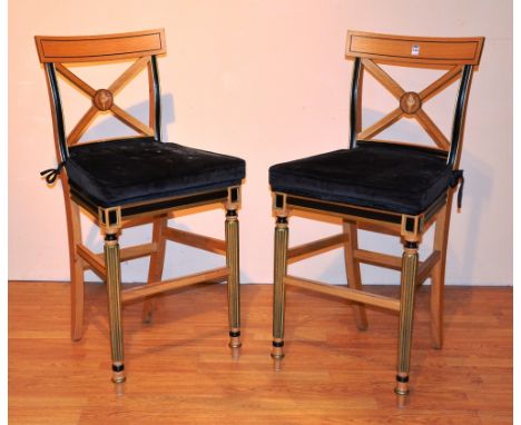 A pair of light oak breakfast bar chairs by Clive Christian, the back rest with X-form stretchers, raised on fitted supports,