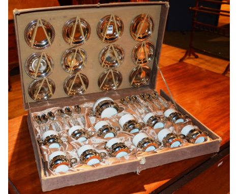 An Italian coffee set by Maioliche Original Derlita, comprising of 12 silver teaspoons, stamped 800, 12 cups with plated hold