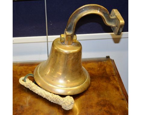 A brass ships bell, with bracket attachment and rope, 31cm high