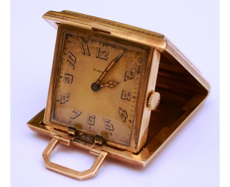 A 14ct gold engine turned travel clock by Eszeha, stamped 585 to case, with carry handle, the dial with Arabic numerals, 45.1