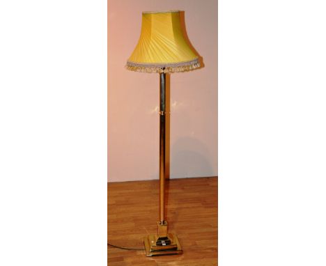 A brass Corinthian style floor lamp with shade, converted to electricity, 161cm high