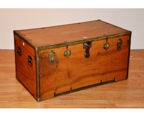 A camphorwood travel trunk, early 20th century, with hinged lid, decorated with metal mounts and metal carry handles, 54cm hi