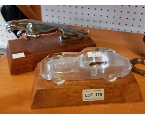 A Jaguar car mascot, mounted on wooden block, together with a glass model of an E-Type