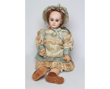 A Tete Jumeau bisque socket head doll, with blue glass paperweight fixed eyes, closed mouth, brown wig, pierced ears, jointed