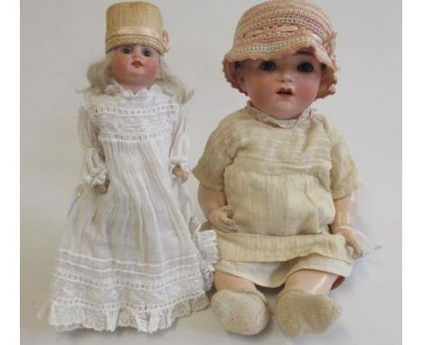 Two bisque socket head dolls, comprising a Franz Schmidt & Co. girl with brown glass sleeping eyes, open mouth, nostrils, int