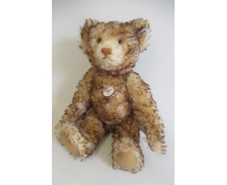 A boxed Steiff replica 1926 teddy, with bi-colour plush, ear button and tag, card label, certificate, felt pads and sewn nose