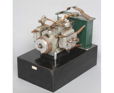 A twin cylinder petrol engine with four spark plugs, two carburetters and eight inlet exhaust valves, a complex engine, no ca