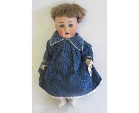 A Schtzmeister & Quendt bisque socket head character doll, with blue glass sleeping eyes, open mouth, teeth, brown wig, mamma