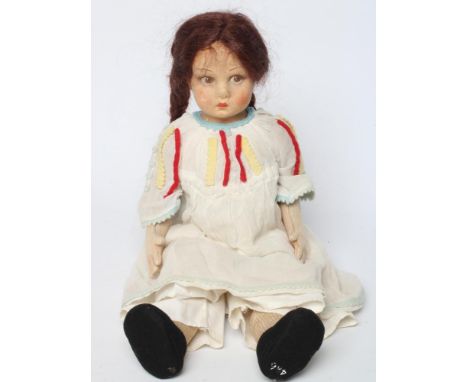 A pre-war Lenci girl doll, with felt head and arms, painted features, brown wig, jointed body, straight legs and white dress,