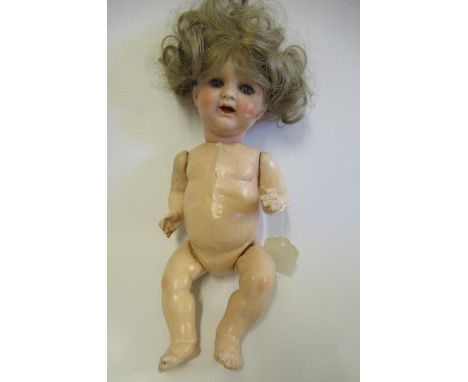A Kammer & Reinhardt bisque socket head character doll, with blue glass sideways glancing eyes, open mouth, light brown wig a