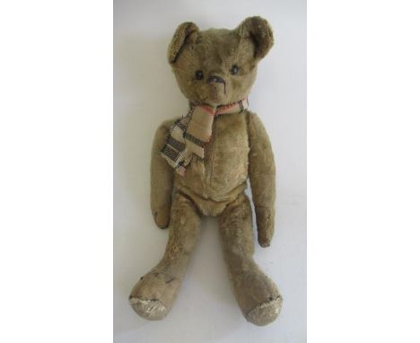 An early shoe button eye teddy, with sewn nose, yellow plush, jointed body and leather pads, 15" longBalding and age througho