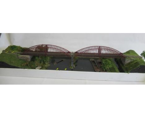 OO gauge model railways layout with large bridge section and terminal station, some buildings in need of repair, and a quanti