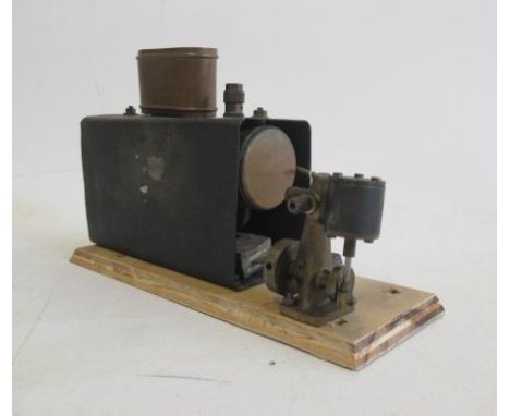 A small oscillating Marine boat engine spirit fired on wood base, F-G