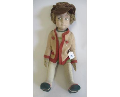 A Lenci (?) boy doll, with felt face and body, painted eyes, straight legs, original felt clothing and later hat, 20 1/4" lon