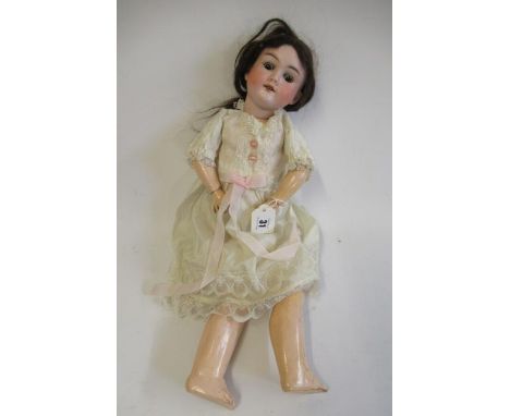 A Max Handwerck bisque socket head doll, with brown glass sleeping eyes, open mouth, upper teeth, brown wig, wood and composi