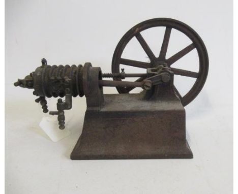 A small hot air engine flywheel and cylinder on cast base, most castings have rust, F, weighs 2.73kg, 10" long, 6 1/2" high a