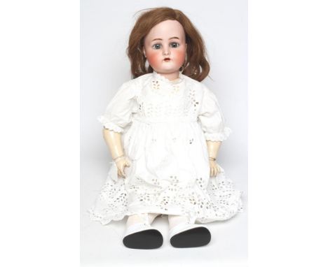 A Kammer & Reinhardt bisque socket head doll, with blue glass sleeping eyes, open mouth, moulded eyebrows, pierced ears, brow