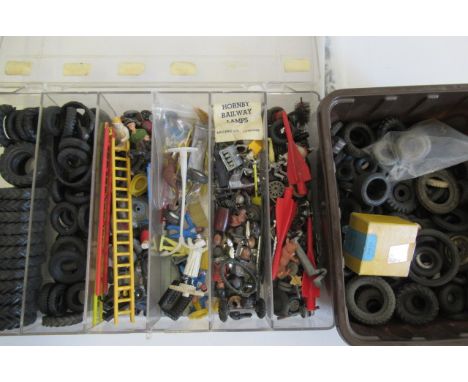 A large quantity of model car tyres and spare parts including figures, tractor and car wheels