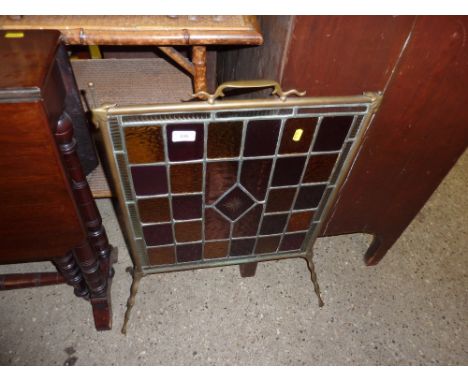 An Art Deco style brass and coloured glass firescreen 