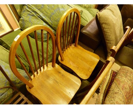 A pair of Ercol elm seated stick back kitchen chairs