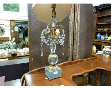 A glass and gilt metal mounted table lamp and shade hung with prism glass drops