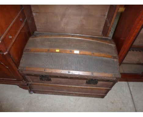 A metal bound and dome topped travelling trunk
