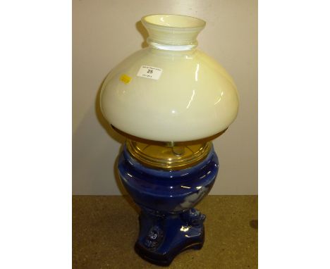 A blue pottery and gilt decorated oil lamp
