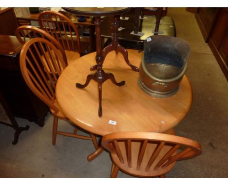A beech circular topped kitchen table with a set of four stick back chairs 