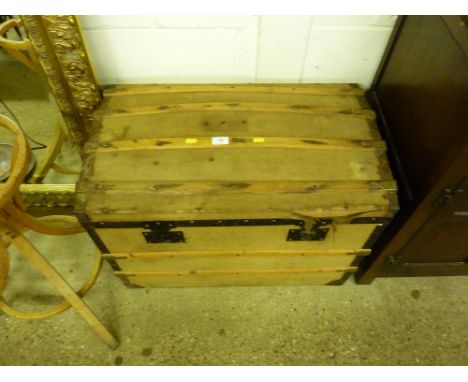 A canvas and wooden bound dome topped trunk