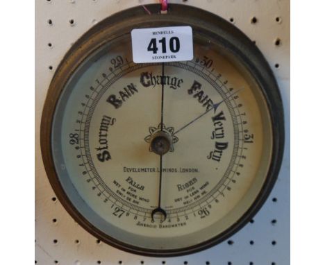 A brass cased bulkhead barometer with aneroid works, the printed dial marked for Develumeter. Luminos. London