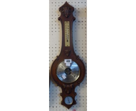 A vintage Weathermaster carved oak cased banjo barometer/thermometer with visible aneroid works to dial centre and humidity d