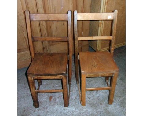 A pair of vintage elm school chairs with moulded solid seat panels and simple square supports