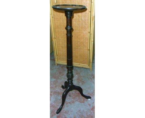 An early 20th Century stained walnut jardinière stand with decorative pillar and tripod base