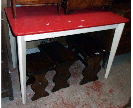 A 3' 6" vintage red Formica topped kitchen table, set on white painted tapered legs