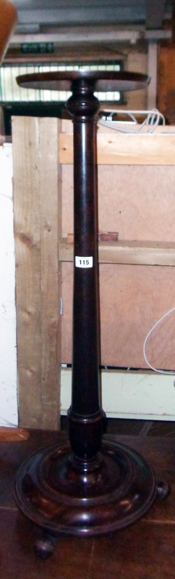 A late Victorian stained mahogany aspidistra stand with tapered turned