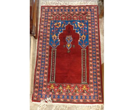 A small prayer rug with mihrab and mosque lamp within repeat floral decoration on red ground - 31" X 4' (78cm X 122cm)