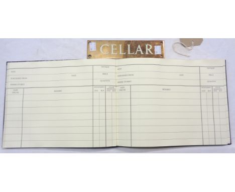 A brass cellar sign - sold with a vintage cellar book