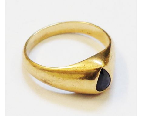 A 1989 Thai yellow metal ring, set with deep cut dark sapphire - complete with original receipt