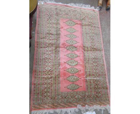 A vintage Princess Bokhara fringe end wool rug with single row of medallions within multi borders and bordered ends on rose m