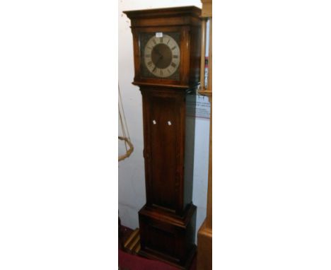 A 20th Century polished oak longcase clock with decorative square dial and triple weight driven eight day chiming movement