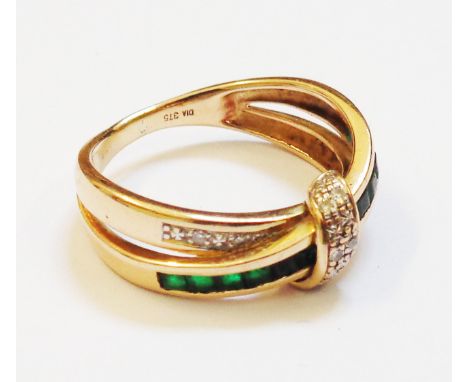 A 375 gold cross-over ring, set with paved green garnets and tiny diamonds 