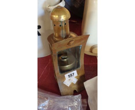 A brass internal ship's lamp with concave front and bezel