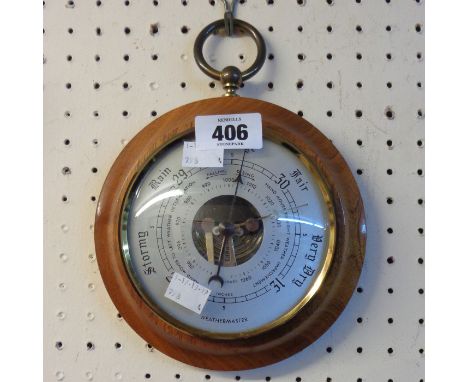 A retro Weathermaster polished wood cased fob style wall barometer with visible aneroid works to dial centre